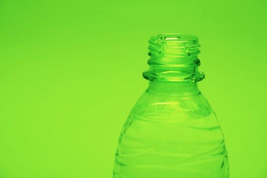 Closeup of a plastic bottle on green background