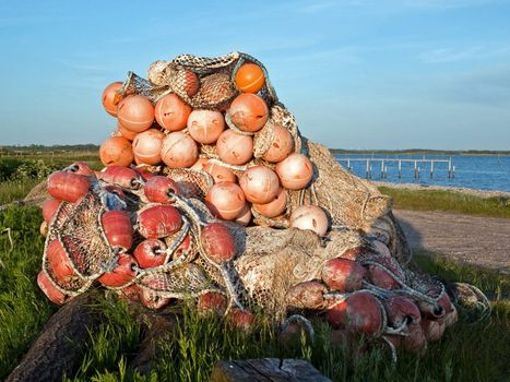 Stack of fishing nets with floats on the beach