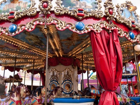 Colorful merry go round carousel horses in an amusement park