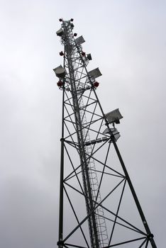 High transmitter tower against overcast sky