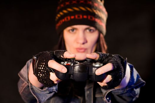 woman gamer with joystick  on darken background