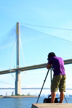 photographer is shooting a bridge