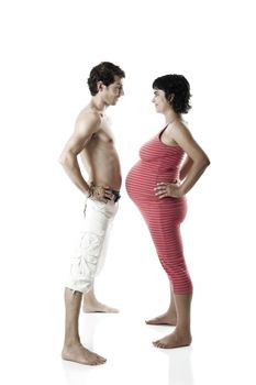 Beautiful couple expecting a baby making funny poses - Isolated on white