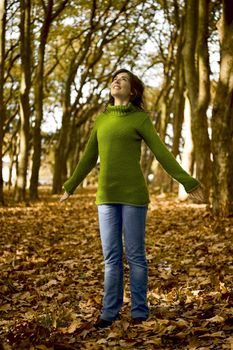 Portrait of a beautiful young woman relaxing in a Autumn background