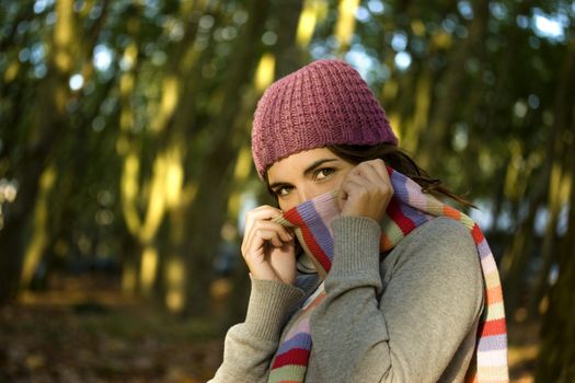 Autumn portrait of a beautiful happy young woman with a colored scarf