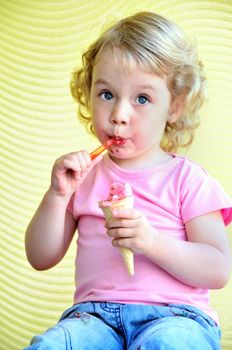 little girl outdoors eating huge ice cream cone