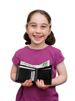 Smiling seven years girl with pigtails holds a wallet with money