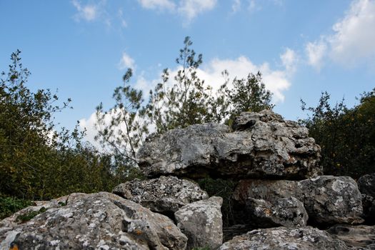 Pyramid of lichen-covered gray rocks in cloudy day