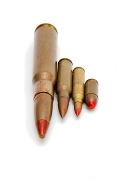 Four red-tipped tracer cartridges of various calibers isolated