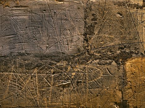 HDR image of scribblings and graffiti on a limestone wall