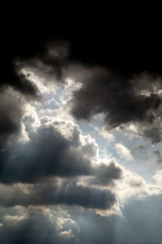 Rays of light coming through thick cloudcover.
