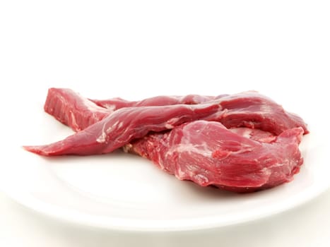 Raw red meat towards white background