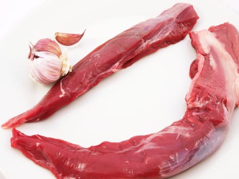 Raw red meat towards white background
