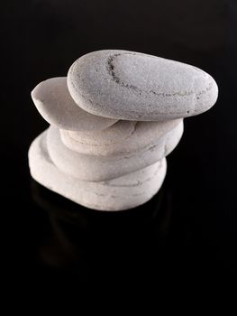 Zen stones pile  on reflective black surface