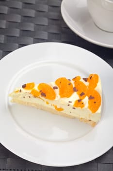 slice of tangerine cream cake on a white plate