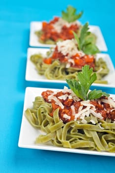 tagliatelle with sauce bolognaise in white plates