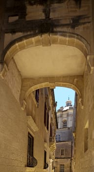 Medieval bridge interconnecting houses in the city of Mdina in Malta