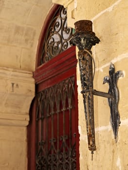 Medieval torch holder on a house in the city of Mdina in Malta