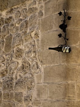 Bottle of wine hanging on a textured limestone wall