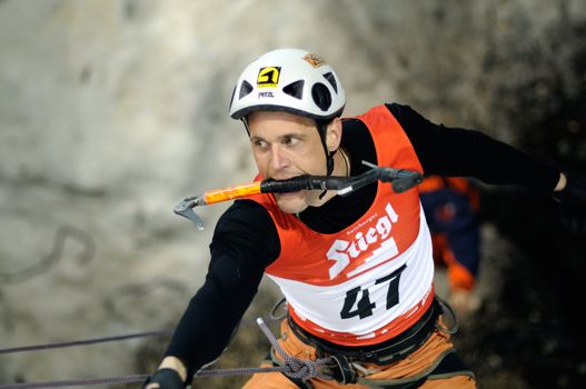 UNKEN, AUSTRIA - FEB 19: Ice climbing european cup finals. Benedikt Purner climbing at the night finals on February 19, 2011 in Heutal, Unken in Austria.