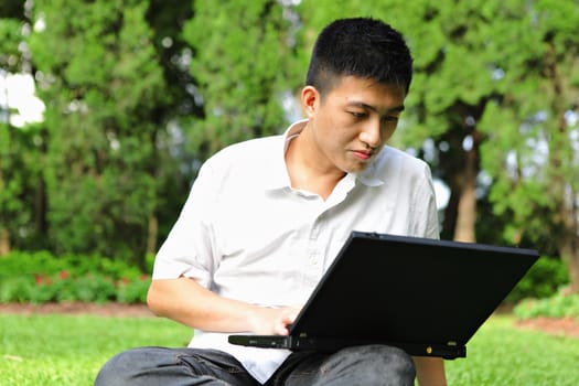 man use laptop in park