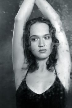 Portrait of the woman in reflection of a wet mirror