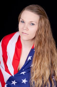A sexy girl with the American flag drapped around her.