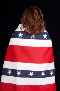 A woman wrapped in a patriotic design.  Photograph is taken from behind.