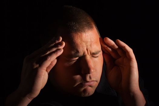 A man that has a serious head ache.  You can see the waves of pain flowing outward from his head.