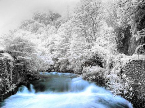 slow motion powerful mountain stream in infrared hdr processed