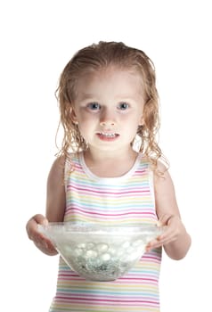 A nervous girl holding a glass bowl.  The bowl has a ball of light inside of it.  The light is glowing onto her face.