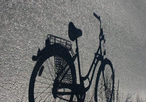 Shadow of bicycle. Concept - sustainable and green thinking, ecological transportation and healthy lifestyle.