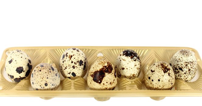 Eggs of japanese quail in little basket isolated on white