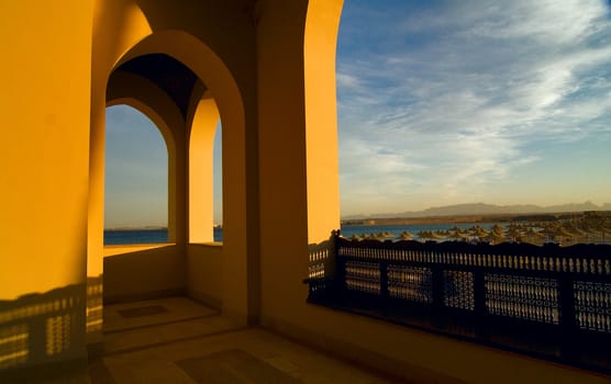 View from a terrace on a beach with umbrellas and the sea