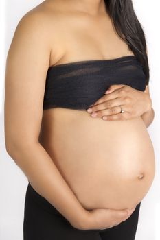 sexy beautiful pregnant semi nude Indian woman in black  on white backdrop