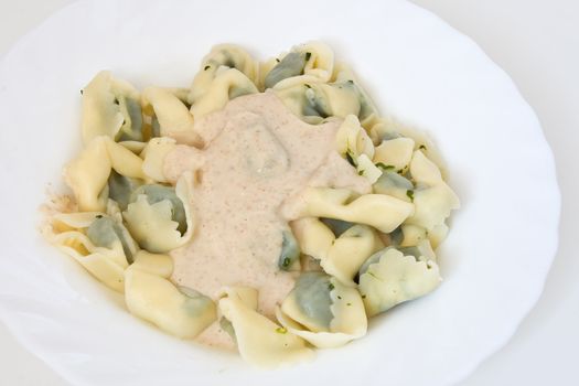Typical dish of Ligurian cooking: paste stuffed like ravioli with walnut sauce