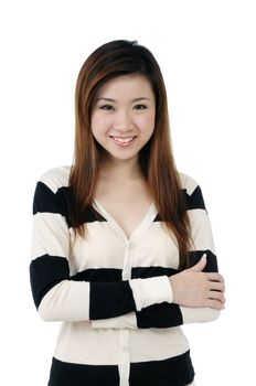 Portrait of an attractive young woman smiling with arms crossed, over white background.