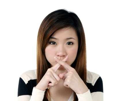 Portrait of pretty young woman with fingers crossed over her lips, isolated on white background.