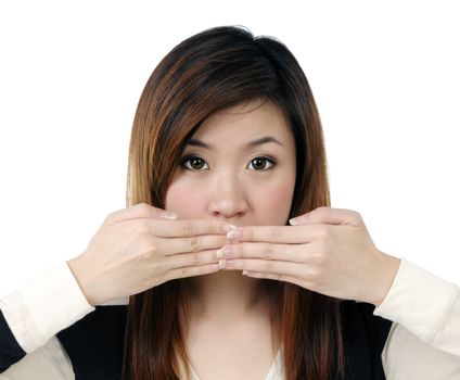 Portrait of an attractive young woman covering her mouth with both hands over white background.