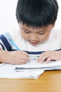 Closeup of an elementary schoolboy doing his school work.