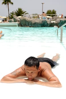 A man is relaxing in swimming pool