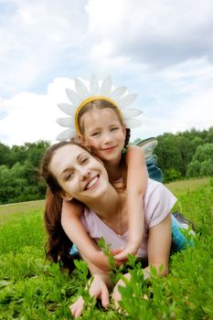 Happy mum and daughter in grass
