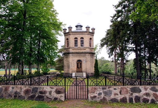 Catholic Church in the woods with a fence