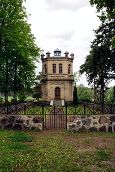 Catholic Church in the woods with a fence