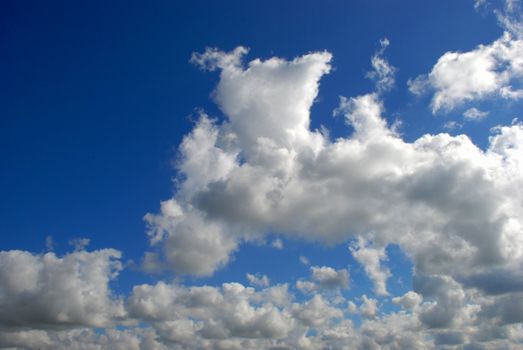 Summer cumulus and their various configurations fills the sky