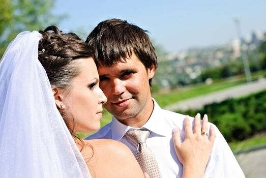 Smiling Bride and Groom hugging each other