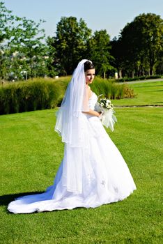 Bride standing on a green meadow