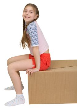 Happy girl sit on the cardboard box