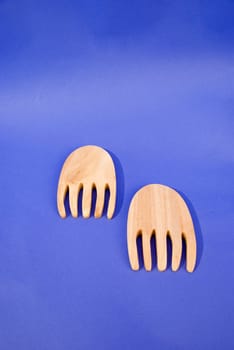 Two wooden foot with long toes isolated on a blue background