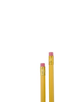 Two yellow pencils with erasers at the ends isolated on white background